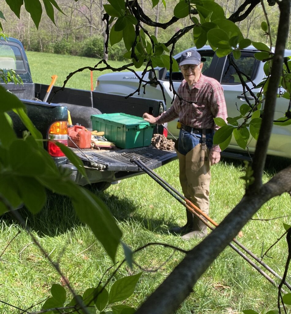 Bernard “Bud” Nagelvoort standing by the tailgate with tacklebox