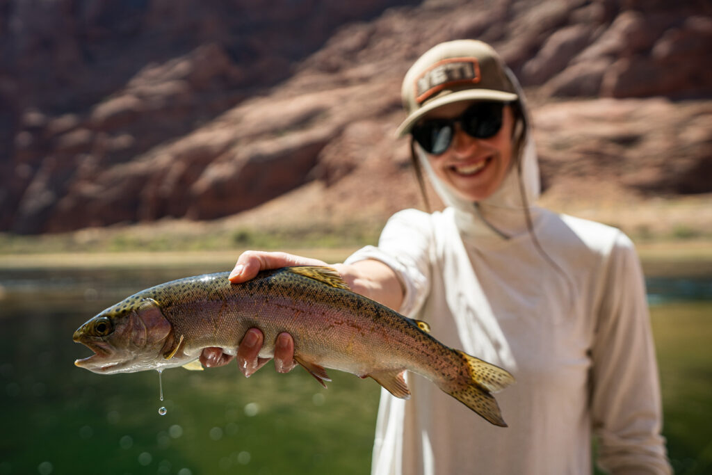 female angler holding rainbow trout