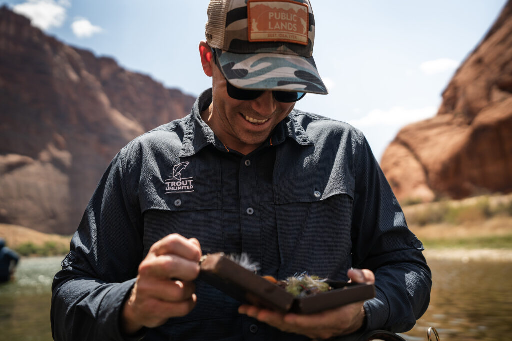 angler looking at flies in his fly box