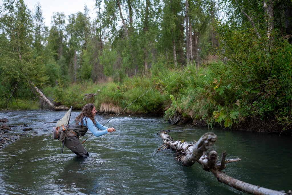 female angler fixing stuck line