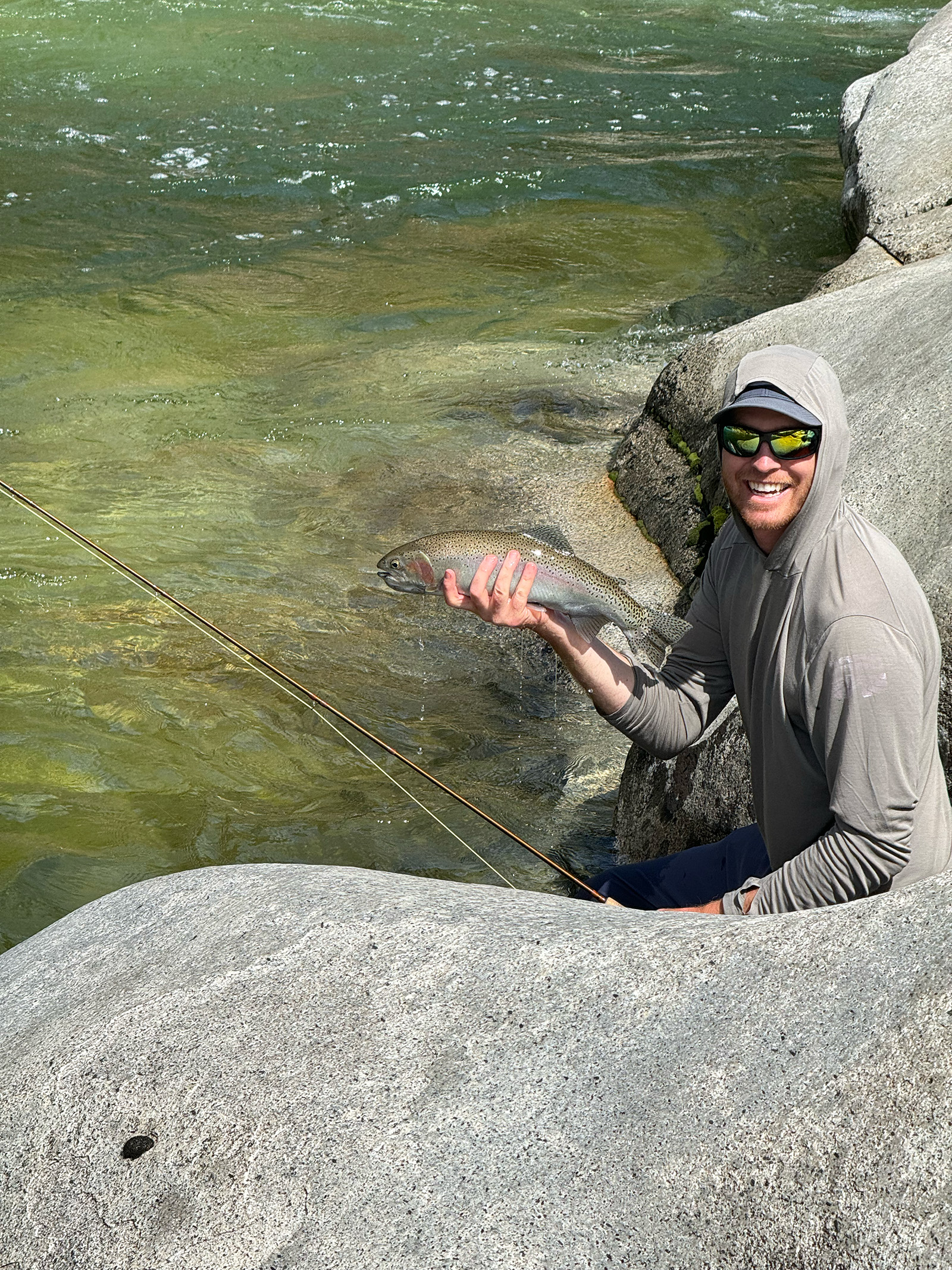 dylan holding a rainbow trout