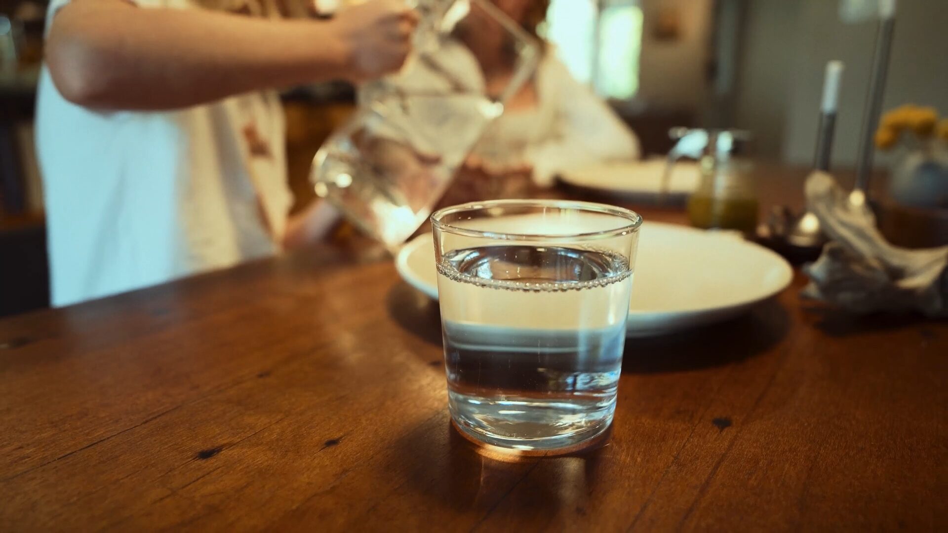 glass of water on table at family dinner