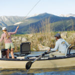 two anglers fishing in boat wearing free fly tu collab limited edition yellowstone cutthroat hoodie