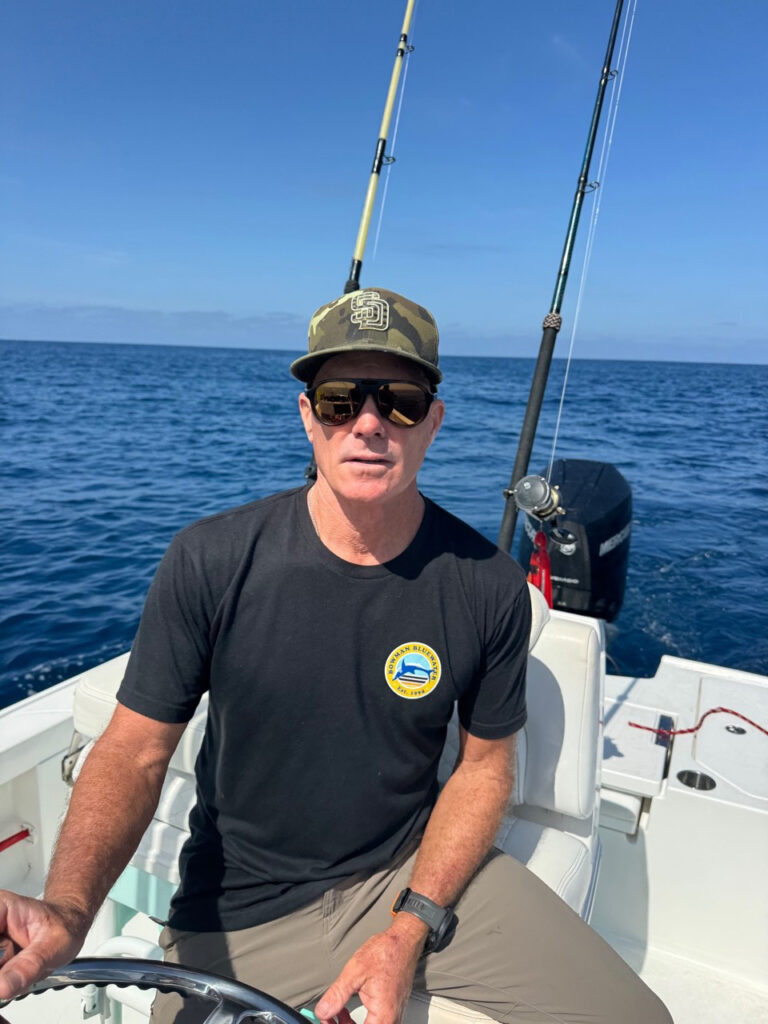 Conway Bowman, pioneer of fishing for mako on the fly, at the helm of the boat