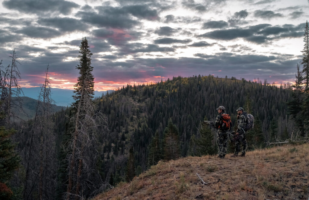 two hunters overlooking beautiful, pristine roadless area sunset