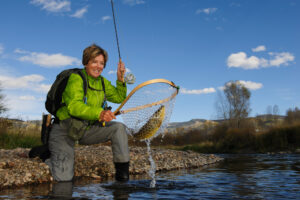 female angler brown trout in net