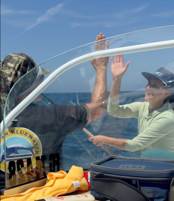 conway and cat high fiving after mako fight
