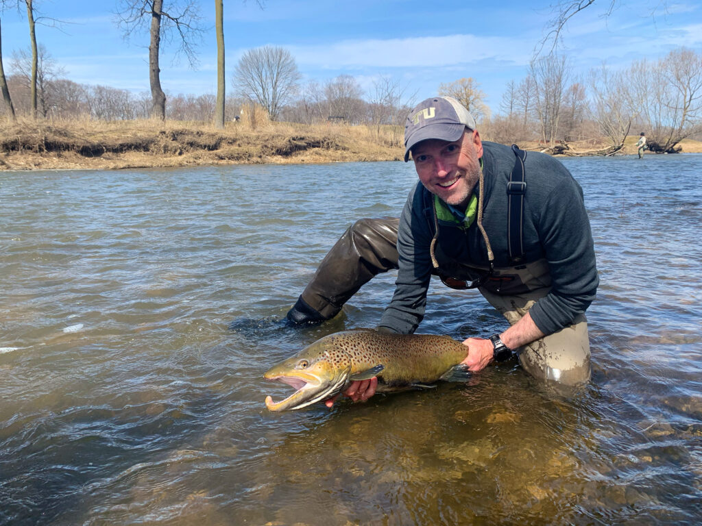 author mark taylor holding large brown with hook jar