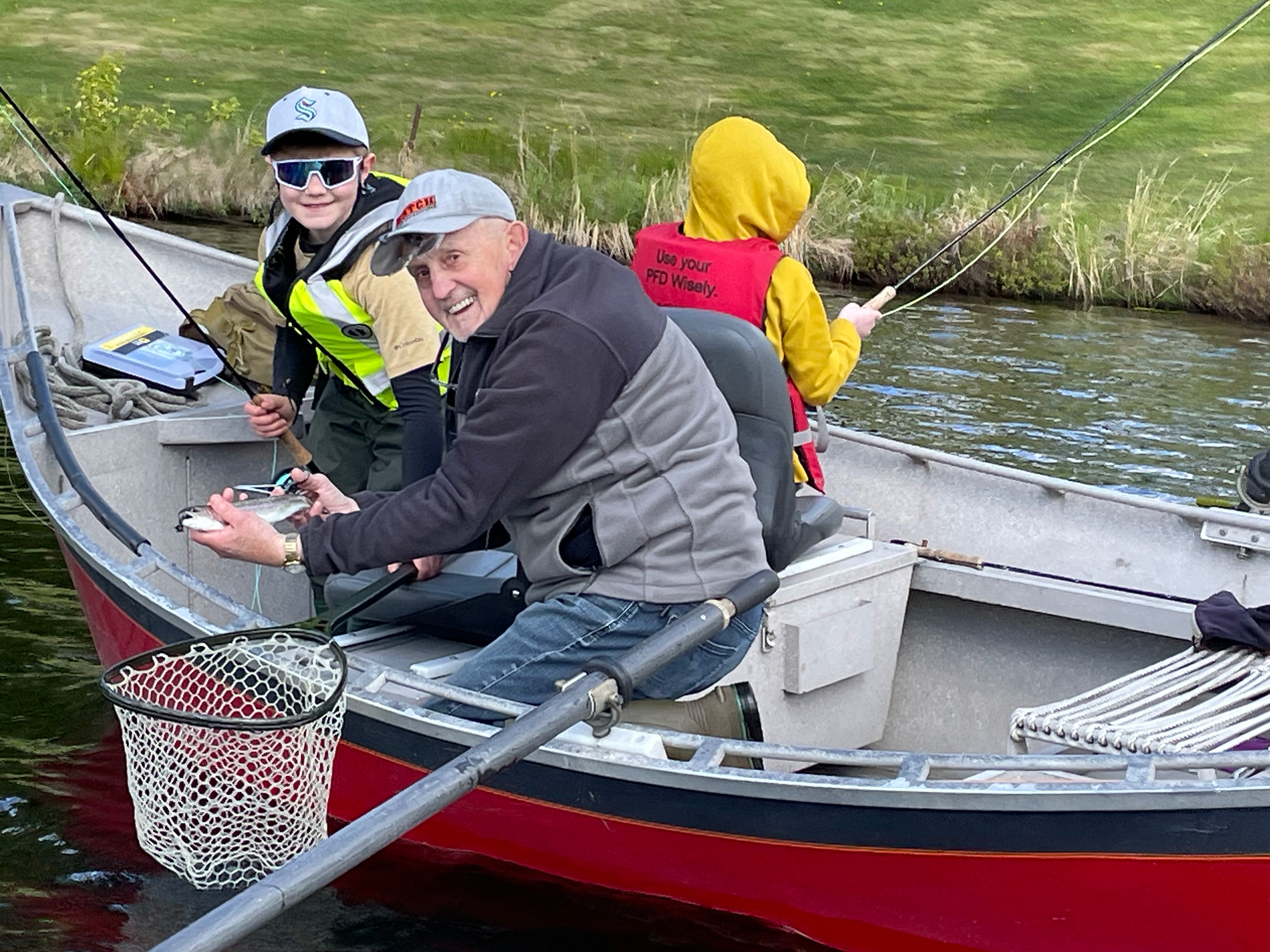 tony lewis fishing with two kids in.a boat